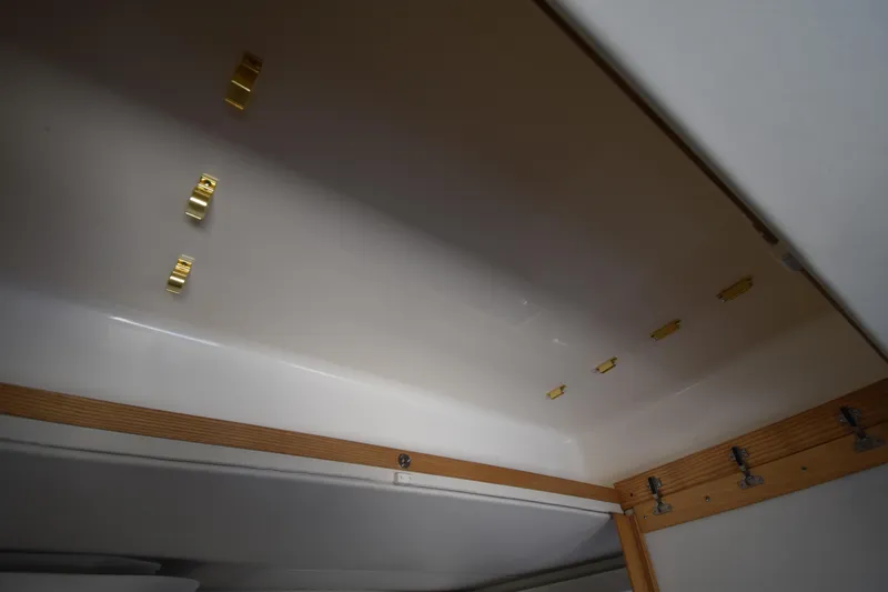  Yacht Photos Pics Interior ceiling of 1997 Tiara 4300 boat with wooden trim and gold fixtures.