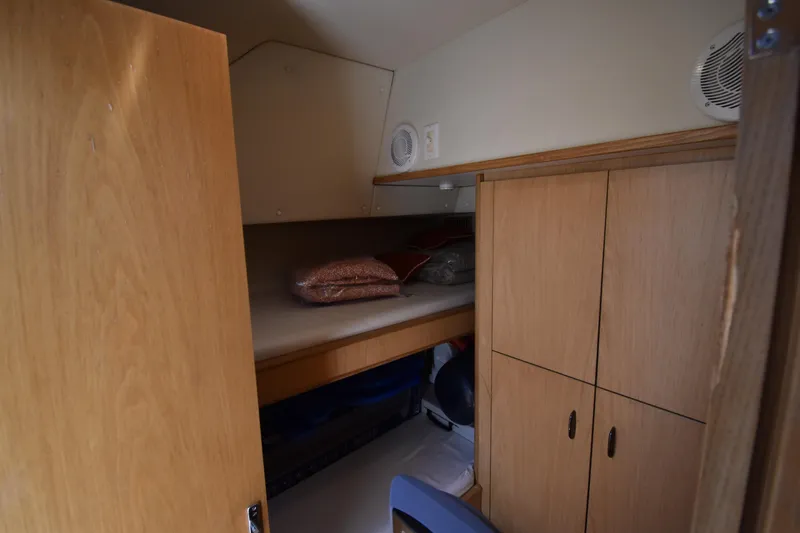  Yacht Photos Pics Cozy cabin interior of 1997 Tiara 4300 yacht with wooden storage and bedding.