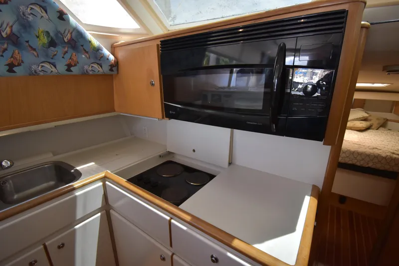  Yacht Photos Pics kitchen in a 1997 Tiara 4300 yacht with stove, microwave, and sink.