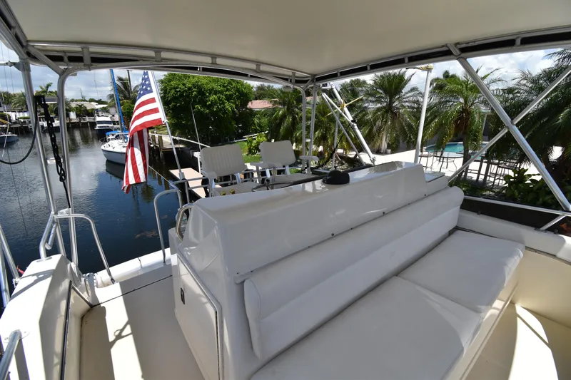  Yacht Photos Pics 1997 Tiara 4300 yacht deck with seating, American flag, and waterfront view.