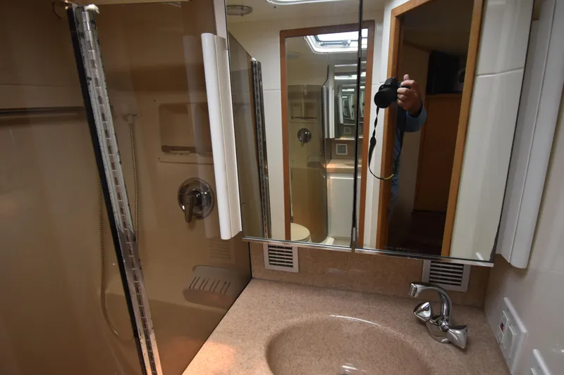  Yacht Photos Pics Bathroom interior of 1997 Tiara 4300 yacht with mirrored cabinet and sink.
