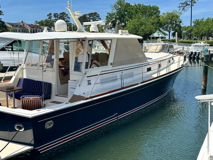 Bella Blue Yacht Photos Pics 2004 Grand Banks 49 Eastbay HX yacht docked in a marina, featuring a sleek design.
