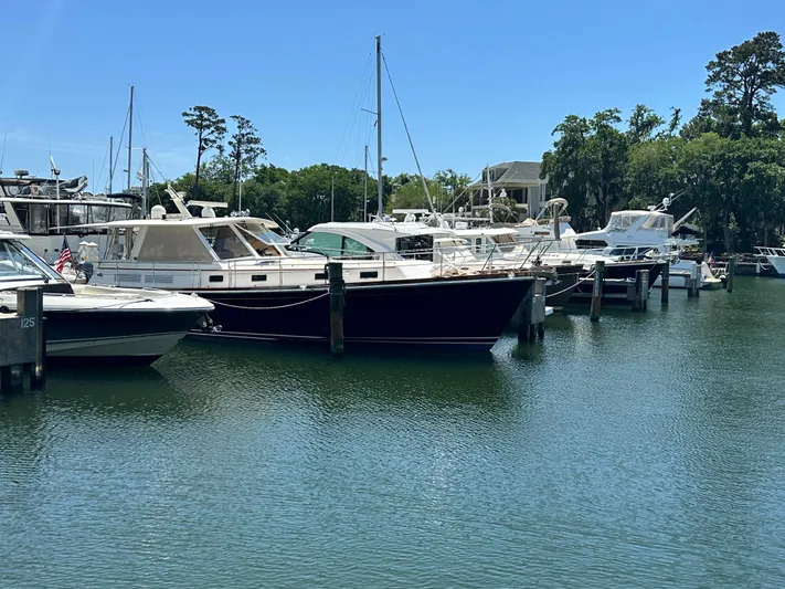Bella Blue Yacht Photos Pics Boats docked at a marina, featuring a 2004 Grand Banks 49 Eastbay HX.