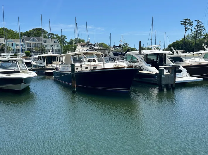 Bella Blue Yacht Photos Pics 2004 Grand Banks 49 Eastbay HX yacht docked in a marina, surrounded by other boats.