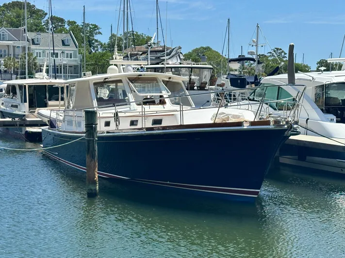 Bella Blue Yacht Photos Pics 2004 Grand Banks 49 Eastbay HX yacht docked in a marina, surrounded by other boats.