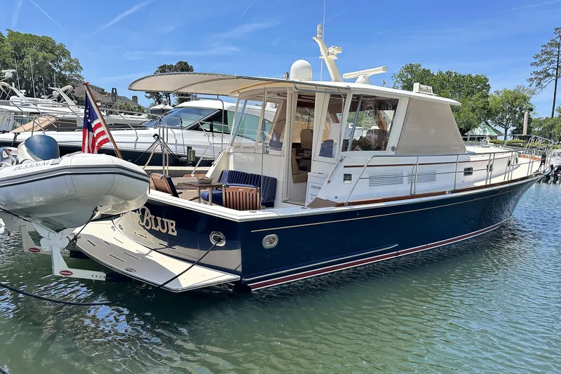 Bella Blue Yacht Photos Pics 2004 Grand Banks 49 Eastbay HX yacht docked in a marina, featuring a sleek design.