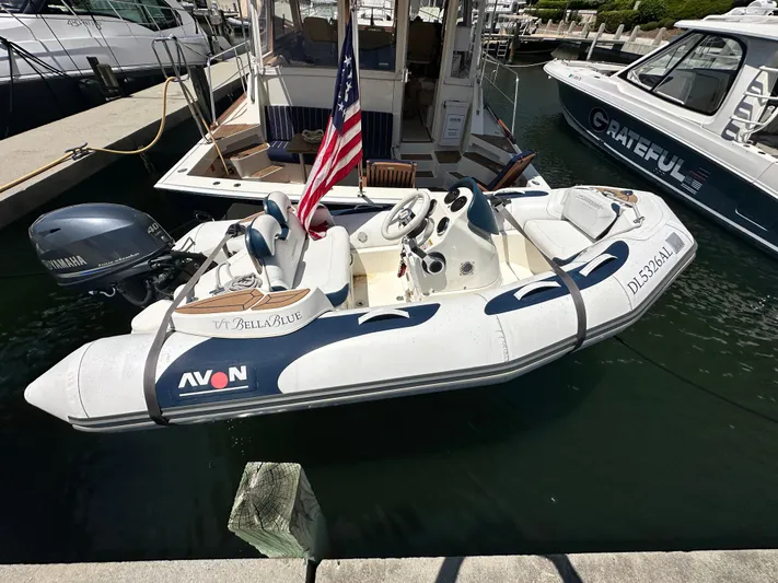 Bella Blue Yacht Photos Pics A 2004 Grand Banks 49 Eastbay HX docked with an Avon inflatable boat nearby.