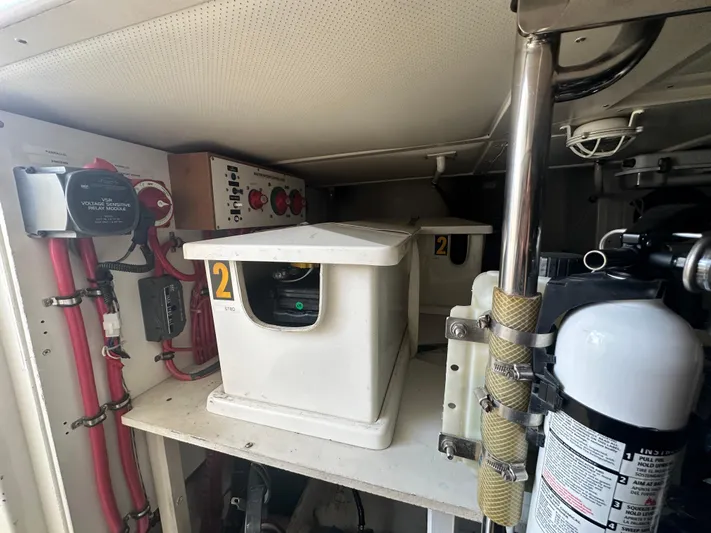 Bella Blue Yacht Photos Pics Engine room of 2004 Grand Banks 49 Eastbay HX with electrical components and fire extinguisher.