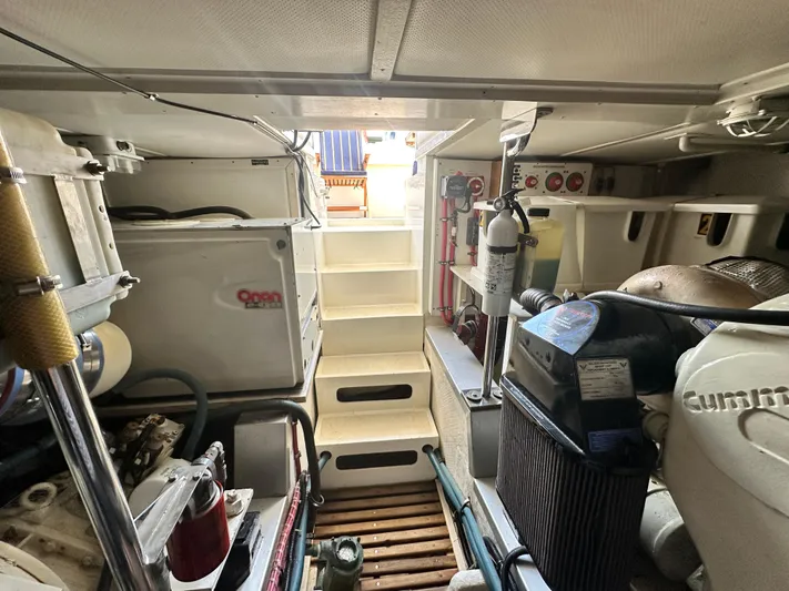 Bella Blue Yacht Photos Pics Engine room of 2004 Grand Banks 49 Eastbay HX with visible equipment and stairs.