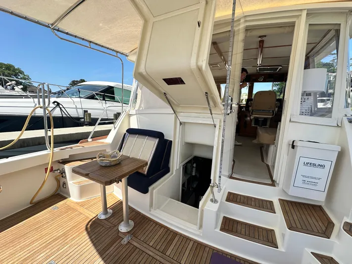 Bella Blue Yacht Photos Pics 2004 Grand Banks 49 Eastbay HX yacht interior with seating and wooden flooring.