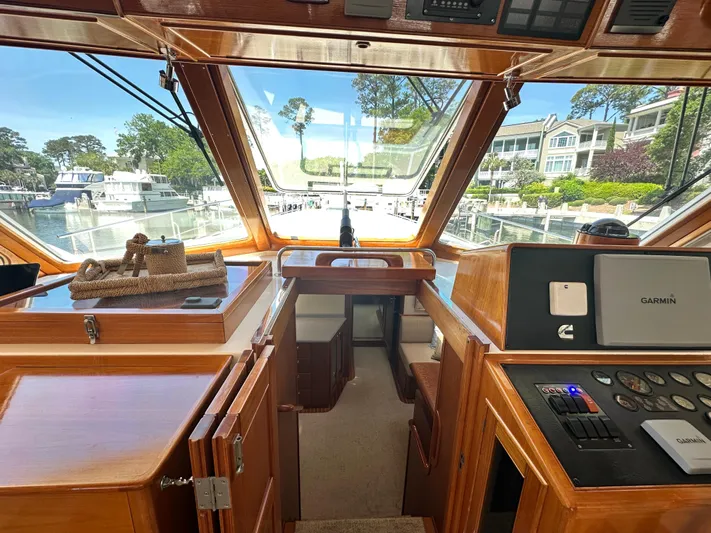 Bella Blue Yacht Photos Pics Interior view of 2004 Grand Banks 49 Eastbay HX yacht, featuring helm and navigation equipment.