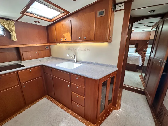 Bella Blue Yacht Photos Pics 2004 Grand Banks 49 Eastbay HX yacht kitchen with wood cabinetry and modern amenities.