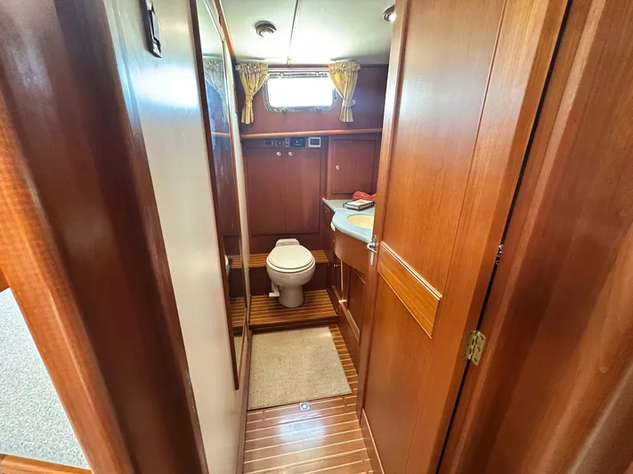 Bella Blue Yacht Photos Pics 2004 Grand Banks 49 Eastbay HX yacht bathroom with wooden interior and modern amenities.