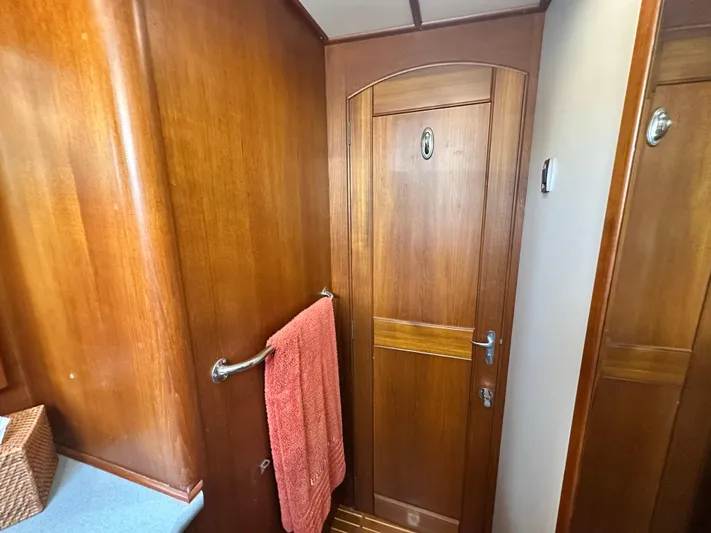 Bella Blue Yacht Photos Pics Wooden interior of 2004 Grand Banks 49 Eastbay HX yacht with towel and door.