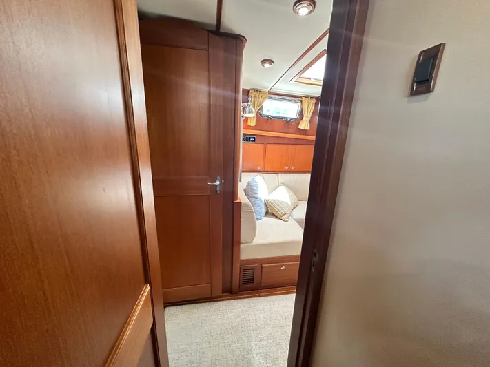 Bella Blue Yacht Photos Pics 2004 Grand Banks 49 Eastbay HX interior with wooden cabinetry and cozy seating area.