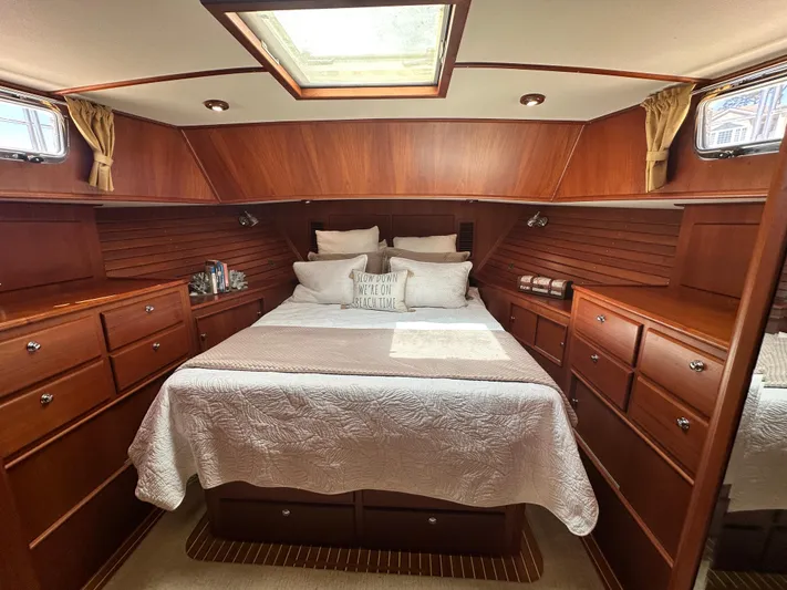 Bella Blue Yacht Photos Pics Luxurious 2004 Grand Banks 49 Eastbay HX cabin with elegant wood finish and cozy bedding.