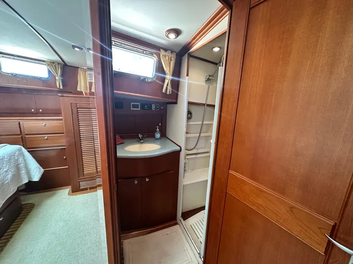 Bella Blue Yacht Photos Pics 2004 Grand Banks 49 Eastbay HX yacht interior with wood finish, bathroom, and bedroom.