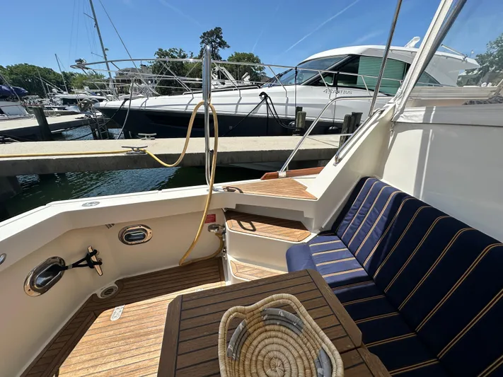 Bella Blue Yacht Photos Pics 2004 Grand Banks 49 Eastbay HX yacht interior with seating and wooden deck.