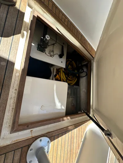 Bella Blue Yacht Photos Pics Storage compartment on 2004 Grand Banks 49 Eastbay HX yacht, featuring equipment and cables.