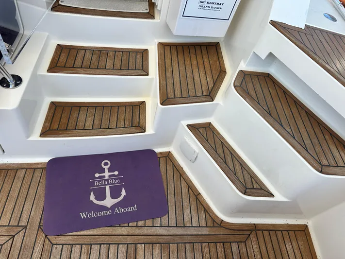 Bella Blue Yacht Photos Pics Teak steps and welcome mat on 2004 Grand Banks 49 Eastbay HX yacht.