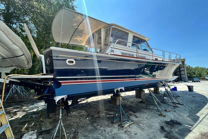 Bella Blue Yacht Photos Pics 2004 Grand Banks 49 Eastbay HX yacht on stands, outdoor setting, clear sky.