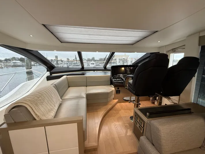 Almost Spoiled 1 Yacht Photos Pics Luxurious interior of 2020 Sunseeker 74 Sport Yacht with plush seating and modern helm.