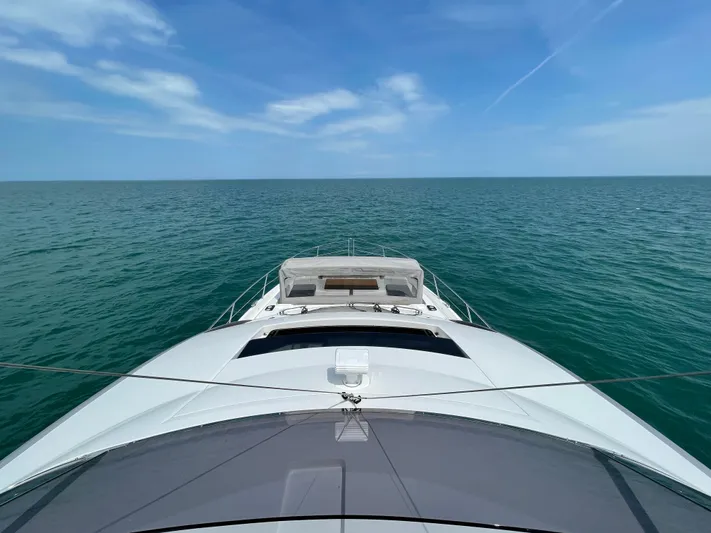 Almost Spoiled 1 Yacht Photos Pics Sunseeker 74 Sport Yacht 2020 cruising on open sea under clear blue sky.