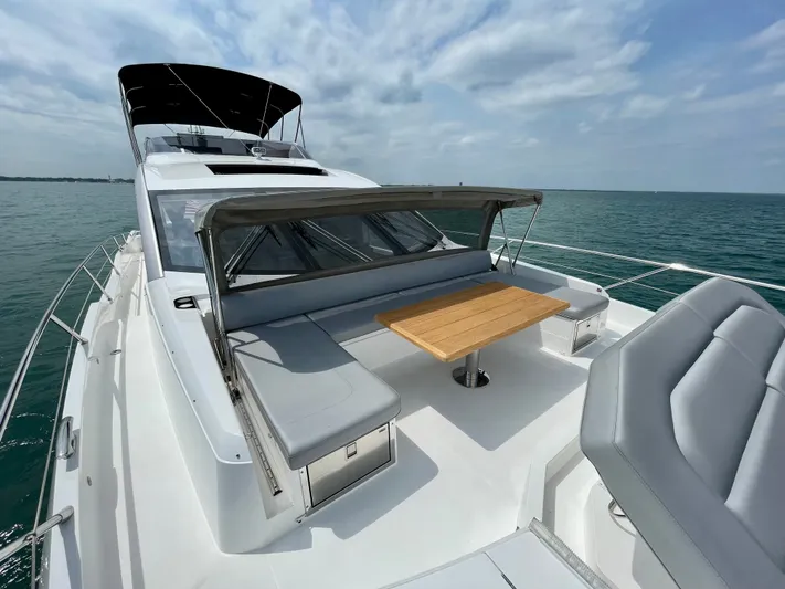 Almost Spoiled 1 Yacht Photos Pics 2020 Sunseeker 74 Sport Yacht with sleek deck and seating, cruising on open water.
