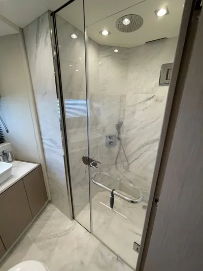 Almost Spoiled 1 Yacht Photos Pics Luxurious bathroom in 2020 Sunseeker 74 Sport Yacht with marble shower and modern fixtures.