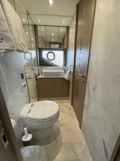 Almost Spoiled 1 Yacht Photos Pics Luxurious bathroom in 2020 Sunseeker 74 Sport Yacht with modern fixtures and elegant design.
