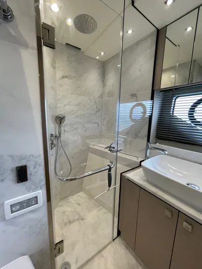 Almost Spoiled 1 Yacht Photos Pics Luxurious bathroom in 2020 Sunseeker 74 Sport Yacht with marble shower and modern fixtures.
