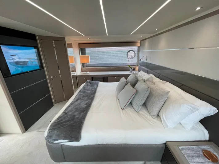 Almost Spoiled 1 Yacht Photos Pics Luxurious bedroom interior of 2020 Sunseeker 74 Sport Yacht with modern decor and ambient lighting.