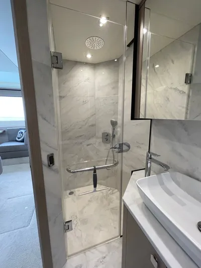 Almost Spoiled 1 Yacht Photos Pics Luxurious bathroom in 2020 Sunseeker 74 Sport Yacht with marble shower and modern fixtures.