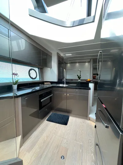 Almost Spoiled 1 Yacht Photos Pics Modern kitchen interior of 2020 Sunseeker 74 Sport Yacht with sleek design and natural lighting.