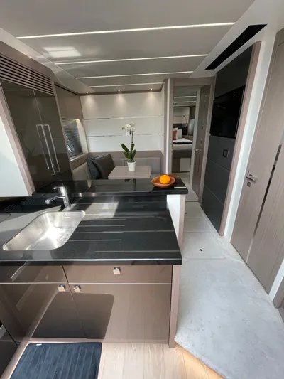 Almost Spoiled 1 Yacht Photos Pics Luxurious interior of 2020 Sunseeker 74 Sport Yacht with modern kitchen and dining area.
