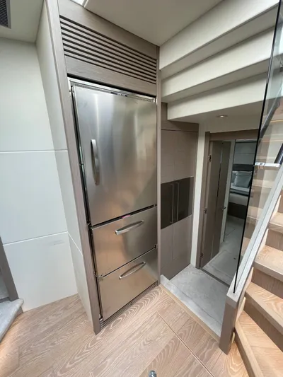 Almost Spoiled 1 Yacht Photos Pics Modern interior of 2020 Sunseeker 74 Sport Yacht with stainless steel appliances and wooden flooring.