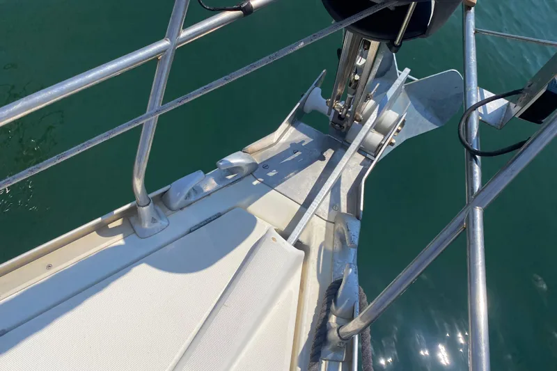  Yacht Photos Pics Jeanneau Sun Odyssey 40 sailboat bow with anchor, 2002 model, on calm water.