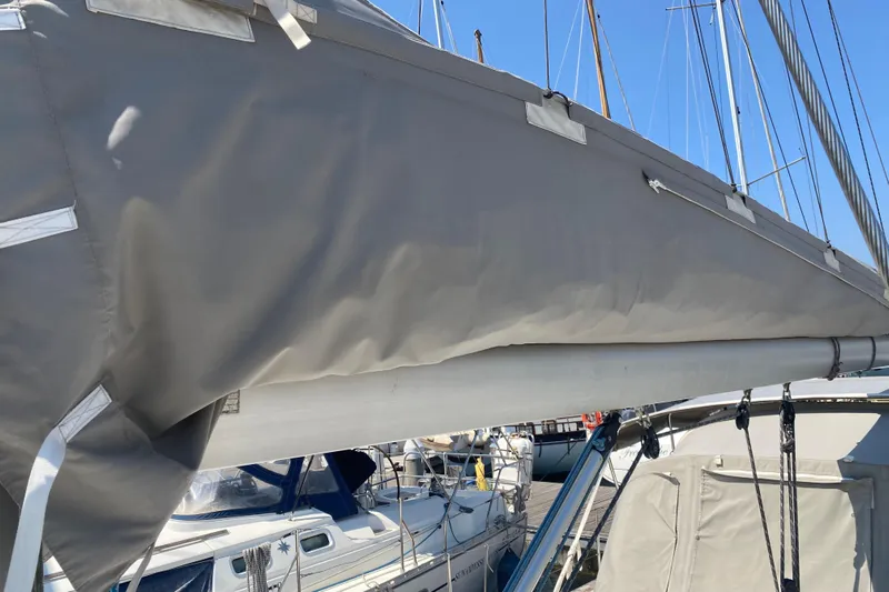  Yacht Photos Pics Jeanneau Sun Odyssey 40 sailboat, 2002 model, with covered boom in marina.