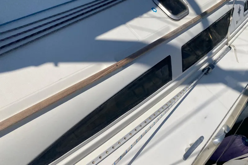  Yacht Photos Pics Deck view of 2002 Jeanneau Sun Odyssey 40 sailboat with sleek design elements.