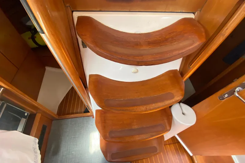  Yacht Photos Pics Wooden steps inside a 2002 Jeanneau Sun Odyssey 40 sailboat cabin.