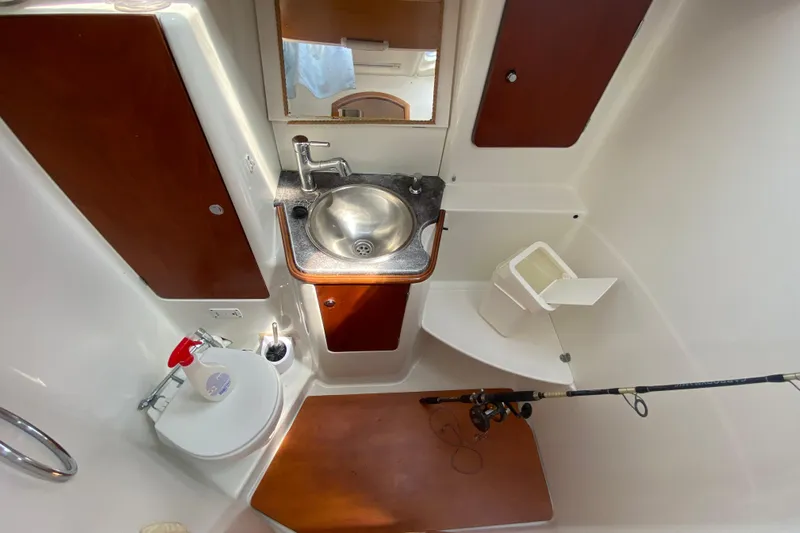  Yacht Photos Pics Jeanneau Sun Odyssey 40 bathroom interior with sink, toilet, and storage, 2002 model.