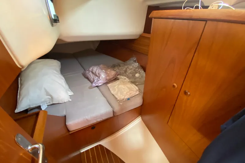  Yacht Photos Pics Cozy cabin interior of 2002 Jeanneau Sun Odyssey 40 sailboat with wooden cabinetry.