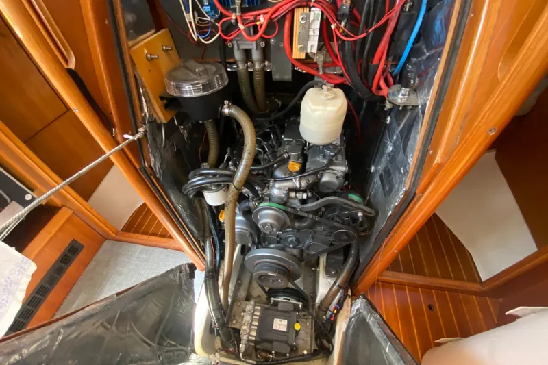  Yacht Photos Pics Engine compartment of 2002 Jeanneau Sun Odyssey 40 sailboat, showcasing detailed wiring and components.