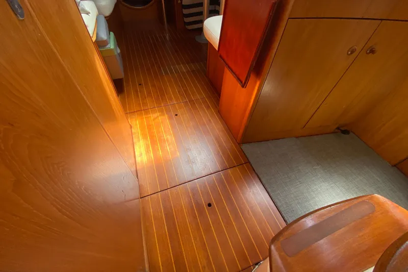  Yacht Photos Pics Interior of 2002 Jeanneau Sun Odyssey 40 sailboat with wooden flooring and cabinetry.