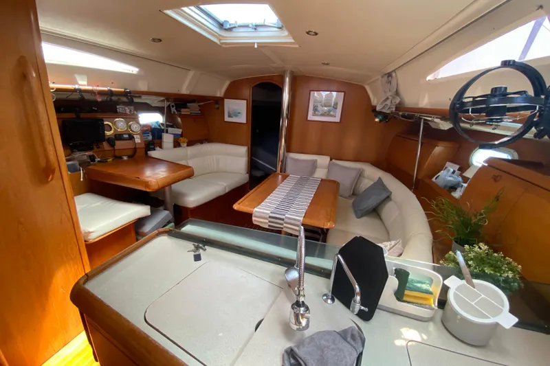  Yacht Photos Pics Interior of 2002 Jeanneau Sun Odyssey 40 sailboat with cozy seating and modern amenities.