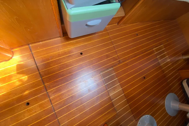  Yacht Photos Pics Wooden interior flooring of a 2002 Jeanneau Sun Odyssey 40 sailboat cabin.