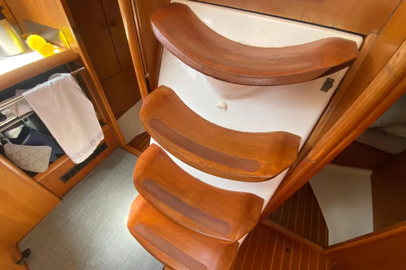  Yacht Photos Pics Wooden steps inside a 2002 Jeanneau Sun Odyssey 40 sailboat cabin.