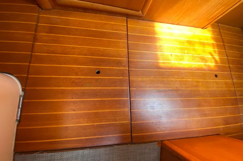  Yacht Photos Pics Wooden interior flooring of a 2002 Jeanneau Sun Odyssey 40 sailboat, with sunlight reflection.