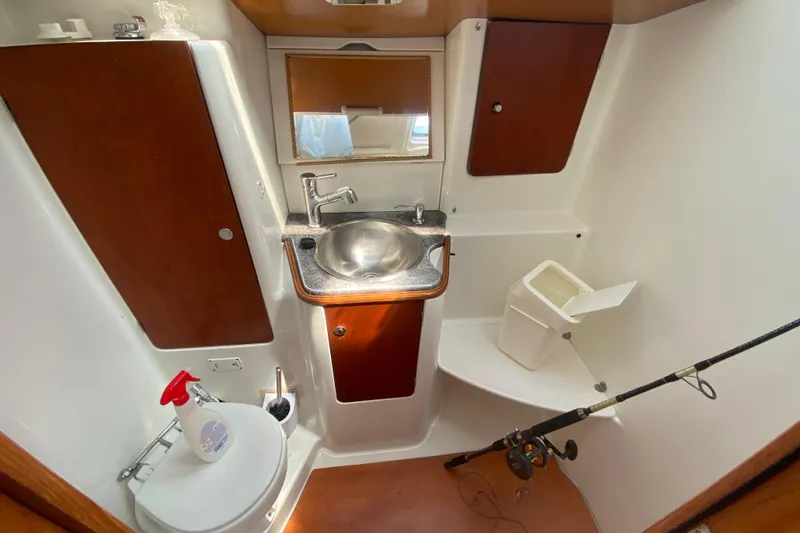  Yacht Photos Pics 2002 Jeanneau Sun Odyssey 40 bathroom with sink, mirror, and toilet.