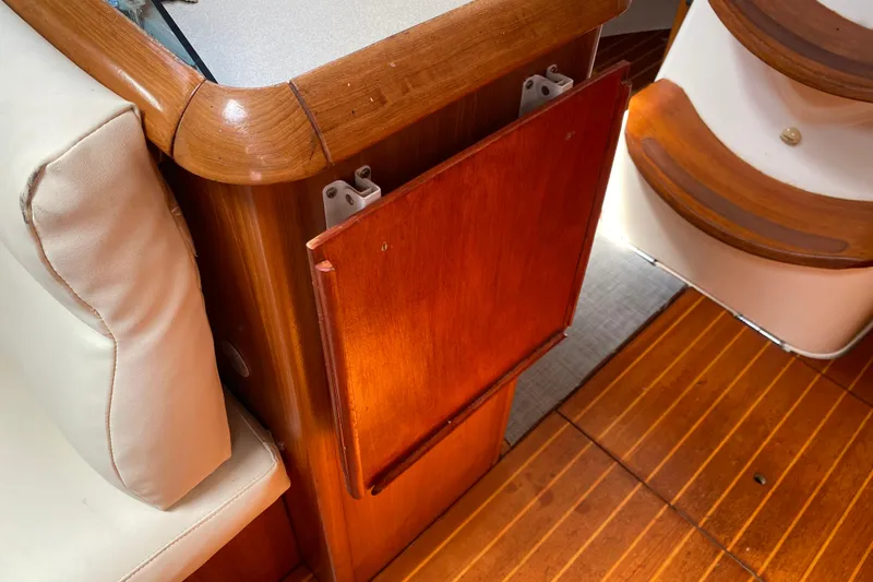 Yacht Photos Pics Interior of 2002 Jeanneau Sun Odyssey 40 yacht with wooden cabinetry and seating.